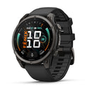 A Garmin fēnix 9 black multisport GPS smartwatch featuring a rugged design, a round AMOLED display that presents the time, date, battery level, step count, and additional fitness metrics, paired with a comfortable silicone strap.