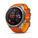 A Garmin fēnix 9 Pro inReach multisport GPS smartwatch with a silver bezel, orange and yellow band, and a digital display that shows time, date, heart rate, steps, battery life, and various fitness metrics. It features advanced satellite connectivity for precise tracking during all your activities.