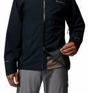 Person showing the 2-way zipper on a black Columbia waterproof jacket