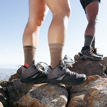 Hikers on a mountain wearing hiking shoes and socks
