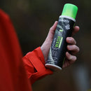 Hand holding a bottle of Grangers Down Wash against a blurred background