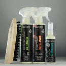 Set of Grangers footwear care products including a brush, cleaner, repellent, and eliminator on a gray background.