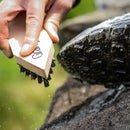 Grangers footwear soft brush being used on a soapy hiking boot sole.