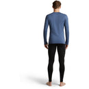 Back view of a person wearing a blue Icebreaker Men’s Merino 260 Tech Long Sleeve Crew and black leggings for cold-weather layering.