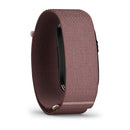 The CIRQA Smart Band by Garmin, featuring a rose-colored textured fabric band and a screenless design for 24/7 health monitoring, is shown from a side angle against a white background.