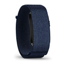 A close-up of the Garmin CIRQA Smart Band in dark blue, featuring a textured fabric band and photographed at an angle that emphasizes the band while partially concealing the screen—an excellent choice for anyone looking for advanced sleep tracking and comprehensive 24/7 health monitoring.
