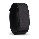 A black Garmin CIRQA Smart Band with a textured fabric strap is pictured at an angle, displaying the fully closed band and just the edge of its device screen. Ideal for 24/7 health monitoring, this sleek accessory is set against a plain white background.