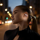 Woman wearing Shokz wireless earbuds with a dark background
