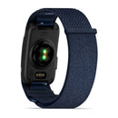 A close-up view of the back of the Garmin CIRQA Smart Band, a screenless fitness tracker featuring a dark blue woven strap, highlights the sensor lights and charging port—ideal for advanced sleep tracking and round-the-clock health monitoring.