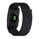Black CIRQA Smart Band by Garmin with a fabric strap, displayed from the back. A green sensor light on the underside highlights its 24/7 health monitoring and advanced sleep tracking capabilities.