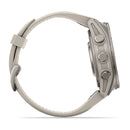 A side view of the Garmin fēnix 9 highlights its beige color, round AMOLED display, three buttons on the right side, and a textured silicone strap with a loop—features characteristic of this latest multisport GPS smartwatch.