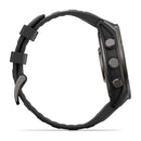 Side view of the Garmin fēnix 9, a black multisport GPS smartwatch featuring three buttons on the right side, a textured rubber strap, and a vibrant AMOLED display.
