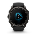 A black Garmin fēnix 9 smartwatch displays a blue glowing play button with phone and microphone icons in the center of its round AMOLED screen.