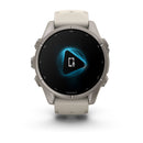The Garmin fēnix 9, a beige multisport GPS smartwatch, showcases its vibrant AMOLED display featuring a glowing blue play icon with a white smartphone and microphone—highlighting its voice or audio capabilities.