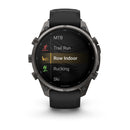 A Garmin fēnix 9 Pro inReach multisport GPS smartwatch with a black band displays exercise options—including MTB, Trail Run, Row Indoor (highlighted), Rucking, and Ski—on its screen, highlighting advanced features typical of the brand.