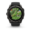 A Garmin fēnix 9 multisport GPS smartwatch in black displays a topographic map on its vibrant AMOLED screen, featuring labeled locations Vestone, Lavenone, and Treviso Bresciano, with visible trails, elevation details, and a red navigation arrow.
