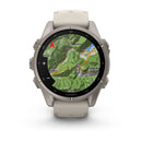 A Garmin fēnix 9 multisport GPS smartwatch with a white band and three side buttons showcases an AMOLED display featuring a topographic map with a red navigation arrow, route line, and labeled locations such as Vestone, Lavenone, and Treviso Bresciano.