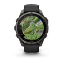 The Garmin fēnix 9 multisport GPS smartwatch in black features a crisp AMOLED display showing a vivid topographic map with detailed terrain, rivers, labeled locations, a red compass arrow, and a 0.2 km distance scale.