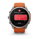 A Garmin fēnix 9 Pro inReach multisport GPS smartwatch with an orange band displays an emergency message: “I have an emergency and I need you to send help.” Thanks to satellite connectivity, the screen also shows Emergency Response and a Reply button below the message—making it clear this advanced watch from Garmin is ready for any adventure.