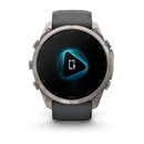 A Garmin fēnix 9 Pro inReach multisport GPS smartwatch with a black band displays a blue glowing icon of a phone with a microphone on its round screen, indicating a voice command or smart assistant feature.