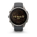 Front view of a Garmin fēnix 9 Pro inReach multisport GPS smartwatch with a black band, displaying a gold contour map design and fēnix 9 Pro inReach text on its circular screen.