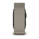 The Garmin CIRQA Smart Band is displayed from a side angle, emphasizing its grey woven band and the sleek edge of the watch face against a white background. This wearable offers 24/7 health monitoring for comprehensive wellness insights.