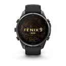 A black Garmin fēnix 9 Pro inReach multisport GPS smartwatch with a black band, featuring a gold topographic map and the text “FENIX 9 PRO” on its round display.