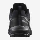 The back or heel of a Black and gray Salomon hiking shoe on a white background 