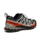 The Salomon Mens XA Pro 3D V9 GORE-TEX Trail Shoe in gray, black, and orange has a rugged sole, quick-lace system, side logo, and waterproof lining—shown from the rear angle—ideal for technical terrain.