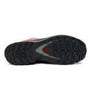 The image shows the black, rugged sole of the Salomon Mens XA Pro 3D V9 GORE-TEX Trail Shoe, featuring an aggressive tread for technical terrain and a small red triangular logo near the center.