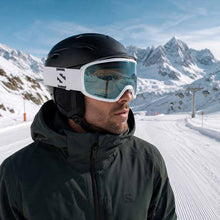 Person wearing a Salomon helmet and goggles in a snowy mountain setting