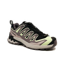 The Salomon Womens XA Pro 3D V9 GORE-TEX Trail Shoe features a black, light green, and gray design with a chunky sole, zigzag accents, GORE-TEX waterproofing, and quick-lace system—perfect for technical terrain.