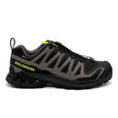 The Salomon Mens XA Pro 3D V9 GORE-TEX Trail Shoe in black and gray with yellow accents features a rugged sole and quick-lace system, shown from the side against a white background.