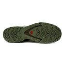 Close-up of the green rubber outsole on the Salomon Mens XA Pro 3D V9 GORE-TEX Trail Shoe, showing its rugged, multi-directional tread for superior traction on technical terrain and a small red triangle near the center.