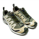 The Salomon Mens XA Pro 3D V9 GORE-TEX Trail Shoe, shown in olive green and beige, features black quick-lace systems, rugged soles for technical terrain, and patterned pull tabs at the heel and tongue against a white background.