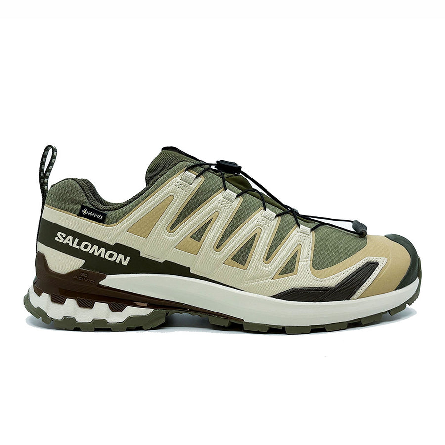 The Salomon Mens XA Pro 3D V9 GORE-TEX Trail Shoe features a green and beige waterproof design, rugged sole, black laces, and side branding—built for technical terrain.