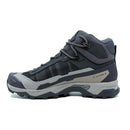 The Salomon Womens X-Ultra 5 Mid GORE-TEX Hiking Boot features a gray and black design, rugged tread, high ankle support, Matryx upper, lace-up closure, and is shown on a plain white background.