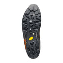 The black sole of the Scarpa Men’s Mont Blanc Pro GTX hiking boot features deep, multi-directional lugs for exceptional traction—similar to those on technical mountaineering boots—and is accented by an orange and yellow Vibram logo near the heel, all set against a white background.