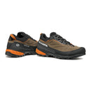 A pair of Scarpa Men’s Rapid XT GORE-TEX hiking shoes in brown, black, and orange are displayed at an angle to showcase both the side and back views. Featuring rugged soles and mesh panels for enhanced breathability, these waterproof approach shoes are crafted to keep you comfortable on any trail.