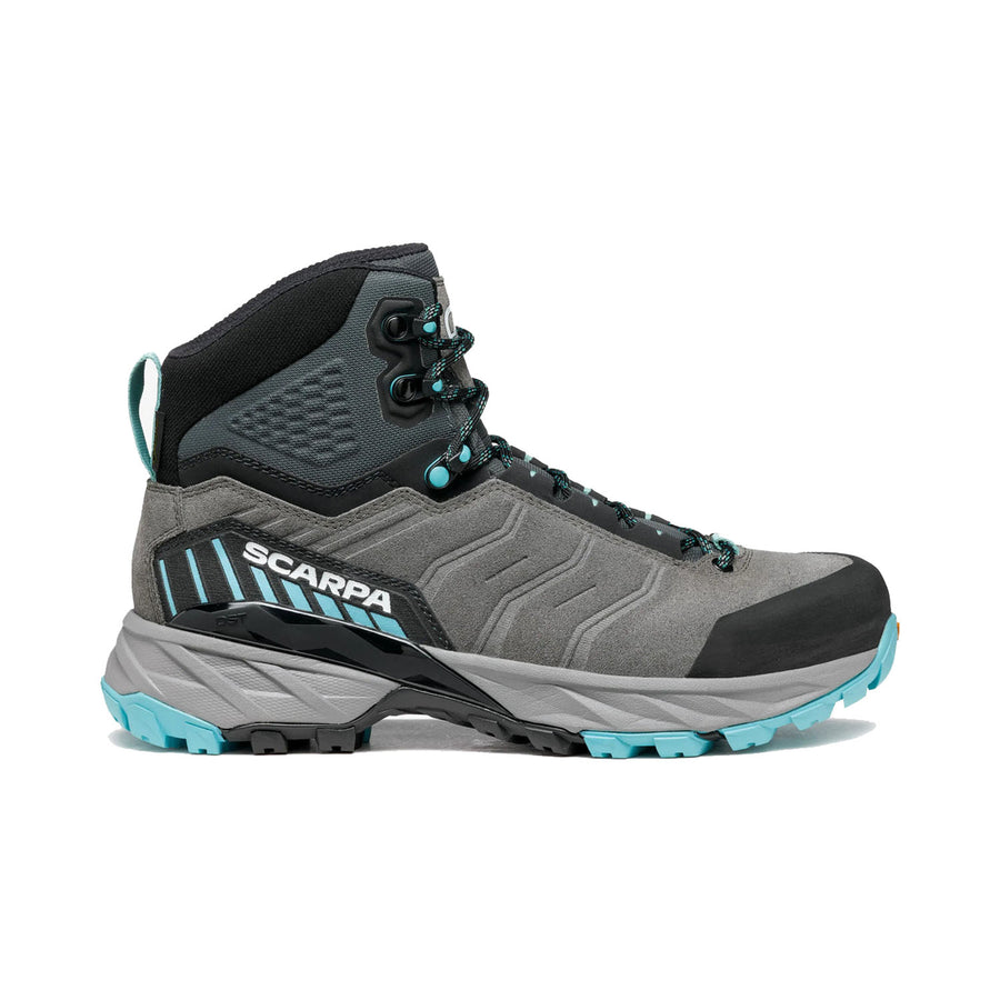Introducing the Scarpa Women’s Rush TRK GORE-TEX hiking boot, designed with a gray and black color scheme accented by turquoise details. This high-ankle boot features a rugged sole for superior traction, SCARPA branding on the side, and a lace-up closure. Crafted with durable materials and GORE-TEX waterproof protection, it’s perfect for outdoor adventures in any weather.