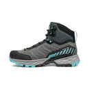 The Scarpa Women’s Rush TRK GORE-TEX is a gray and teal hiking boot designed for women, featuring black accents, mid-ankle height, a rugged sole, and teal laces. It comes with reinforced toe and heel areas for enhanced durability and displays striped detailing along the sides for added style.