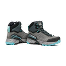 A pair of Scarpa Women’s Rush TRK GORE-TEX hiking boots in gray and teal with black accents, turquoise laces, and rugged soles. Featuring GORE-TEX waterproof technology for superior comfort and protection on any trail, one boot stands upright while the other is positioned to display the side and back details.