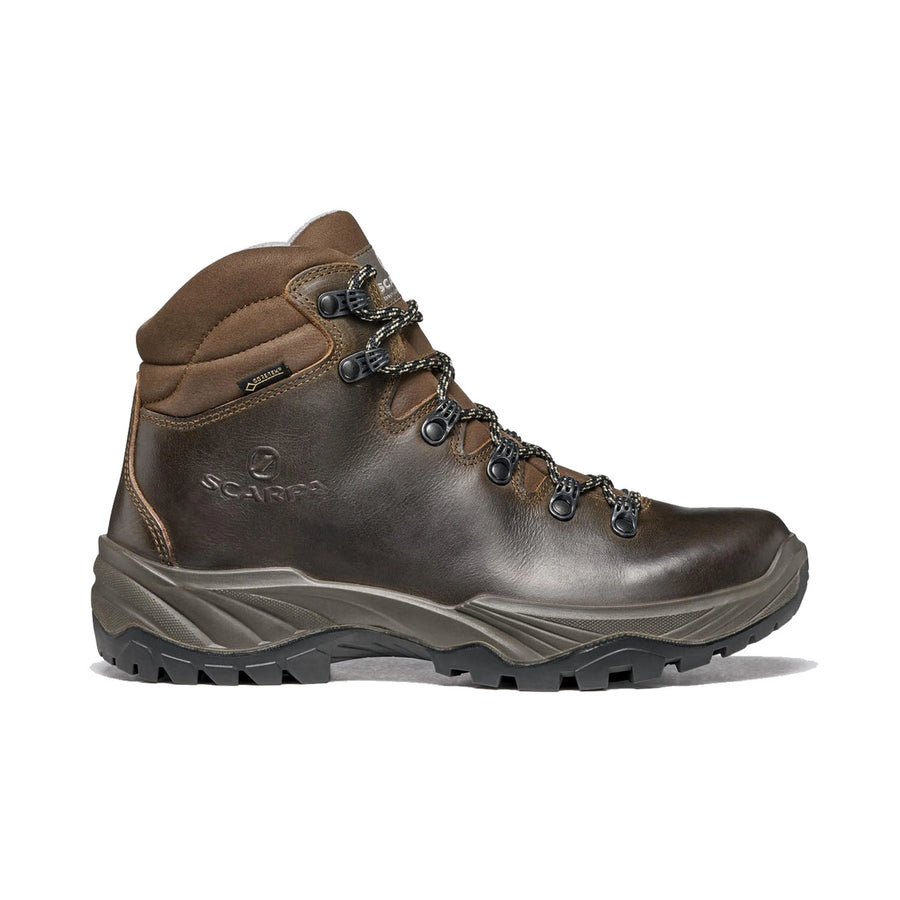 The Scarpa Women’s Terra GTX Hiking Boot is crafted from brown leather and features black laces, a rugged black sole, and metal eyelets. Designed for outdoor use, this waterproof boot includes ankle padding and displays the Scarpa logo on the side. Ideal for adventurers, it delivers comfort and durability on any trail.