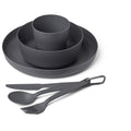 A dark gray, compact Sea to Summit Camp Dinnerware Set w/ Mesh Sack including a plate, bowl, cup, fork, spoon, and knife, with the utensils secured by a carabiner.