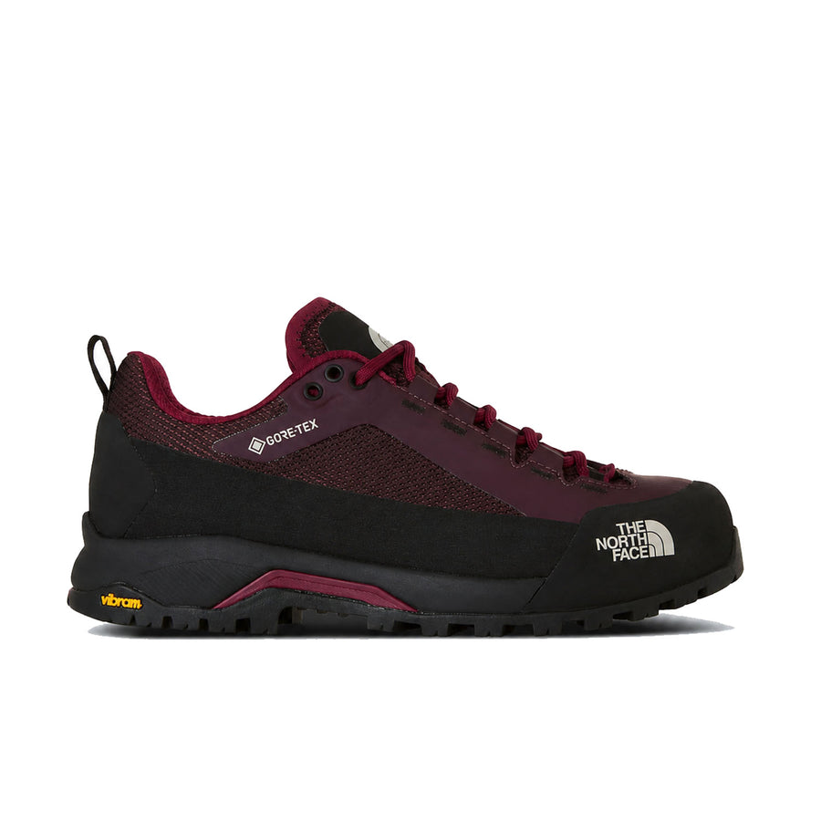 A single The North Face hiking shoe in black and burgundy, featuring a breathable mesh upper, lace-up closure, and rugged Vibram sole, shown against a plain white background.