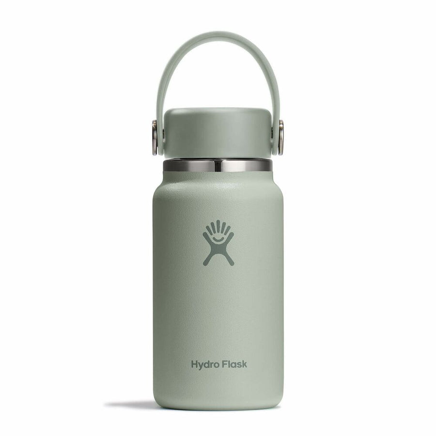 A light green Micro Hydro Mini Bottle by Hydro Flask, featuring a handle, silver cap band, and the Hydro Flask logo on the front, is displayed against a plain white background. This insulated bottle boasts a compact, leakproof design, making it ideal for convenient hydration on the move.