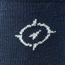Close-up of a navy blue sock with a white embroidered logo.